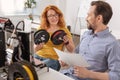 Delighted positive woman holding two filament coils