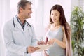 Delighted pregnant woman asking about diagnosis