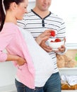 Delighted pregnant woman eating strawberries Royalty Free Stock Photo