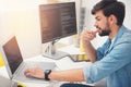 Delighted programmer working on a laptop