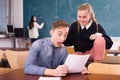 Delighted teenager and female schoolmate reading notification Royalty Free Stock Photo