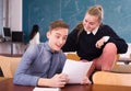 Delighted teenager and female schoolmate reading notification Royalty Free Stock Photo