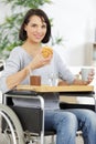 delighted woman in wheel chair having breakfast Royalty Free Stock Photo