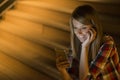 Delighted young woman reading an sms on her mobile phone smiling with excitement at the good news as she stands outdoors in a park Royalty Free Stock Photo