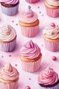 A delightful array of colorful cupcakes topped with pink and white frosting, adorned with sprinkles and candy, set against a soft