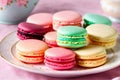 Macarons, arranged in an assortment of vibrant colors, sit atop a table adorned with a pink tablecloth.