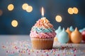 A delightful birthday treat, a cupcake, rests on a light surface