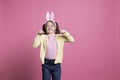 Delightful child imitates a rabbit for the Easter celebration