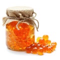 Delightful cloudberry jam marmalade jelly preserves in a glass jar, accompanied by fresh cloudberries, displayed on a clean white