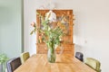 A delightful dining room with a wooden cupboard for dishes