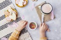 Delightful Easter, child adorns cookies with colorful sprinkles flat lay