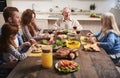 Delightful family eating together in kitchen