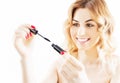 Delightful girl brings eyebrow color with a professional brush. Royalty Free Stock Photo