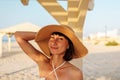 Delightful girl enjoying her holiday at sea. Happy beautiful young woman smiling on the beach Royalty Free Stock Photo