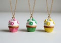 Delightful handcrafted polymer clay cupcake necklaces on gold chains Royalty Free Stock Photo
