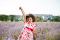 Delightful happy smiling little girl with bouquet of flowers in lavender field