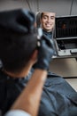 Delightful Indian man with beautiful smile in barber shop