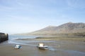 Delightful landscape of small beach at Trefor, north Wales, with two small boats at low tide