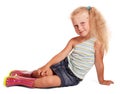 Delightful little blond girl in rubber boots sitting isolated. Royalty Free Stock Photo