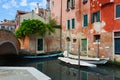 A delightful and original glimpse of a Venice canal with colorful houses