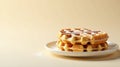 A delightful stack of golden waffles, delicately dusted with powdered sugar, rests elegantly on a pristine white plate against a Royalty Free Stock Photo