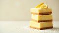 A delightful stack of lemon dessert squares, delicately dusted with powdered sugar and garnished with lemon slices, rests on a Royalty Free Stock Photo