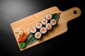 Delightful sushi display on wooden surface with condiments Royalty Free Stock Photo