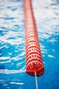 The delimiter is hard lanes in the pool.Red plastic. Swimmers, competitions, track