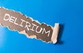 Delirium word written under torn paper, concept