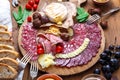 Delisious snacks on wooden board: sausages, bread, cheese, chestnuts and beer. Close view. Royalty Free Stock Photo