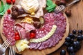 Delisious snacks on wooden board: sausages, bread, cheese, chestnuts and beer. Close view. Royalty Free Stock Photo