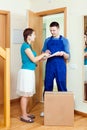 Delivary man in uniform delivered a box to young woman Royalty Free Stock Photo