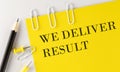WE DELIVER RESULT word on the yellow paper with office tools on white background