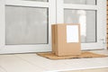 Delivered parcel on door mat Royalty Free Stock Photo