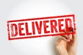 DELIVERED stamp held by a hand, presenting a clear parcel confirmation mark suited for shipping status updates, logistics Royalty Free Stock Photo