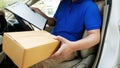 Deliverer sitting in a van holding a box Royalty Free Stock Photo