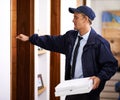 Delivering direct to your door. a young man making a home delivery. Royalty Free Stock Photo