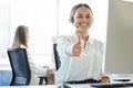 Delivering exceptional service. a young woman showing thumbs up while working in a call center. Royalty Free Stock Photo