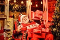 Delivering gifts. Santa Claus near christmas tree. Merry christmas. Bearded senior man Santa Claus. Santa Claus relaxing Royalty Free Stock Photo
