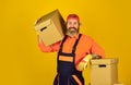 Delivering packages. Bearded man courier hold boxes. Moving to new apartment. Post service. Bearded loader in uniform Royalty Free Stock Photo