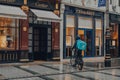 Deliveroo driver in front of Cartier store on Bond Street, London, UK