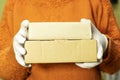 Delivery against Coronavirus 2019-nCov in pandemic Contactless delivery. woman hand in medical gloves holds carton box. Concept o