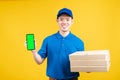 Delivery asian male presentation order pizza in box with smartphone green screen