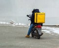 Delivery boy of takeaway on scooter with isothermal food case box. Express food delivery service from cafes and restaurants. Royalty Free Stock Photo