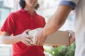 Delivery business service concept. Delivery Man sending packages to customer in front of house door Royalty Free Stock Photo