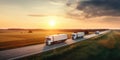 delivery cargo trucks driving in motion on highway road in country field and sunset landscape concept of lorry logistic freight Royalty Free Stock Photo