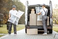 Delivery company employees unloading cargo van vehicle Royalty Free Stock Photo