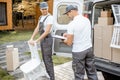 Delivery company employees unloading cargo van vehicle Royalty Free Stock Photo