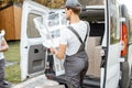 Delivery company employees unloading cargo van vehicle Royalty Free Stock Photo