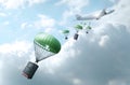 Delivery concept. Airplane drops suitcases and bags on background of clouds.